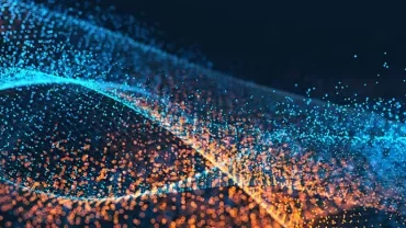 暗い背景に青とオレンジの粒子が渦を巻く抽象的なイメージ。