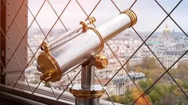Viewing telescope overlooking a cityscape from a high vantage point.